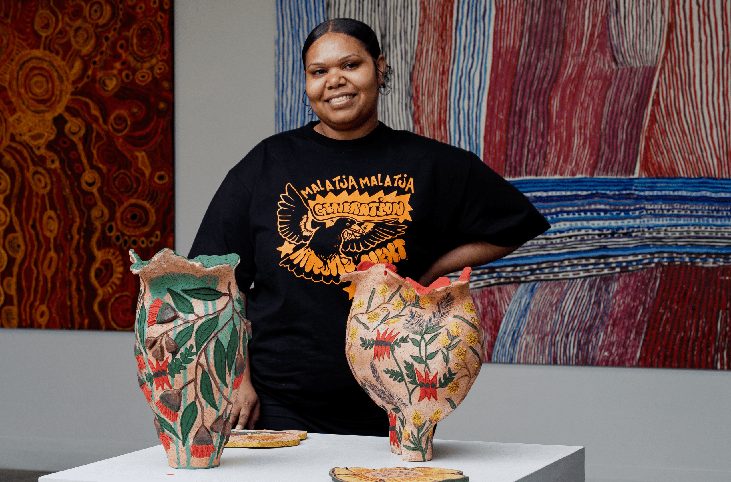 People gather outside West Space on the open walkways and benches